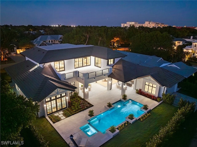 460 2nd Ave N, Naples, FL 34102 - rear view of property with french doors, a pool with connected hot tub, a balcony, a patio area, and stucco siding