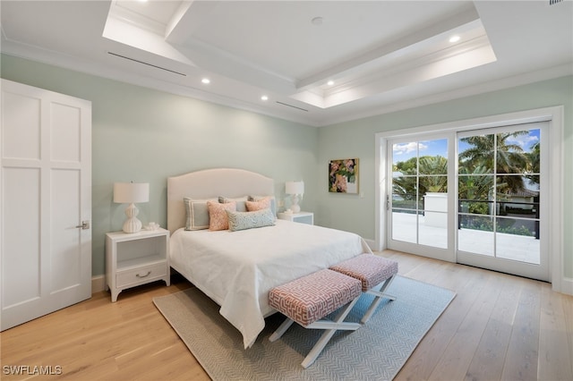 bedroom featuring access to exterior, ornamental molding, a raised ceiling, and light wood-type flooring