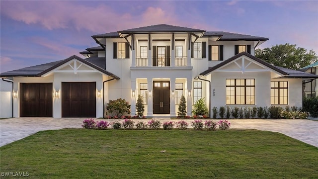 view of front of house featuring a garage and a yard