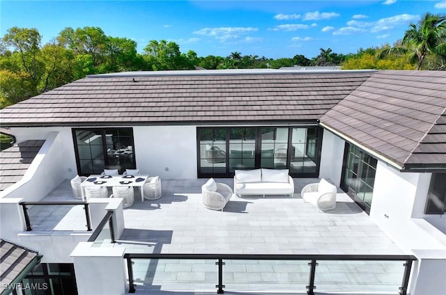 460 2nd Ave N, Naples, FL 34102 - rear view of property featuring a patio, outdoor lounge area, and stucco siding