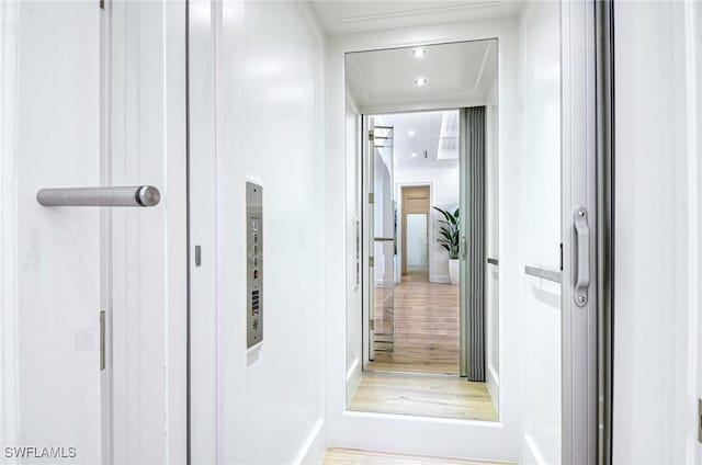 460 2nd Ave N, Naples, FL 34102 - corridor with light wood-style floors, attic access, baseboards, and elevator