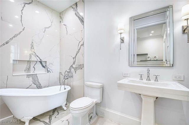 460 2nd Ave N, Naples, FL 34102 - bathroom featuring marble tiled flooring, a freestanding tub, toilet, and a sink