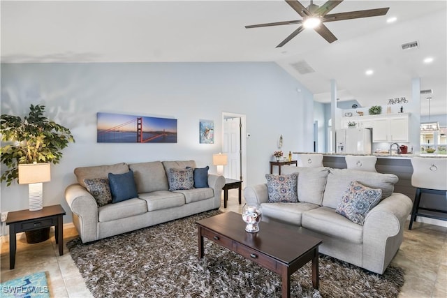 living room with ceiling fan, sink, and vaulted ceiling