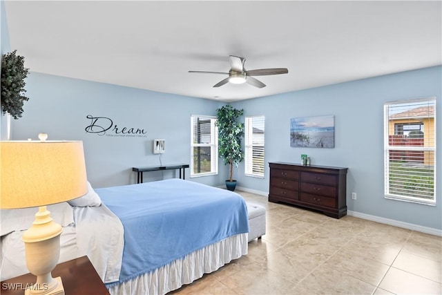 tiled bedroom featuring ceiling fan