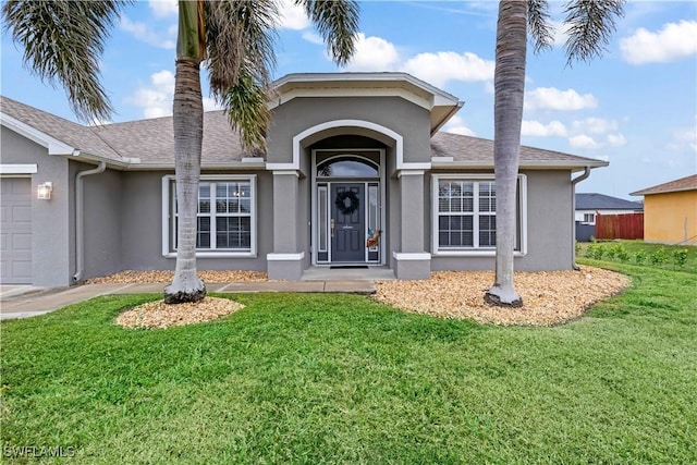 view of front facade featuring a garage and a front lawn