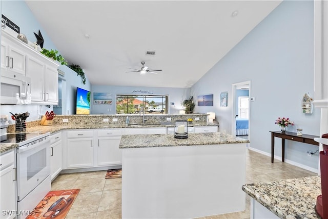 kitchen featuring white cabinetry, white appliances, sink, and a kitchen island