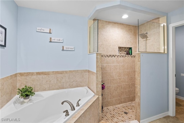 bathroom featuring toilet and separate shower and tub