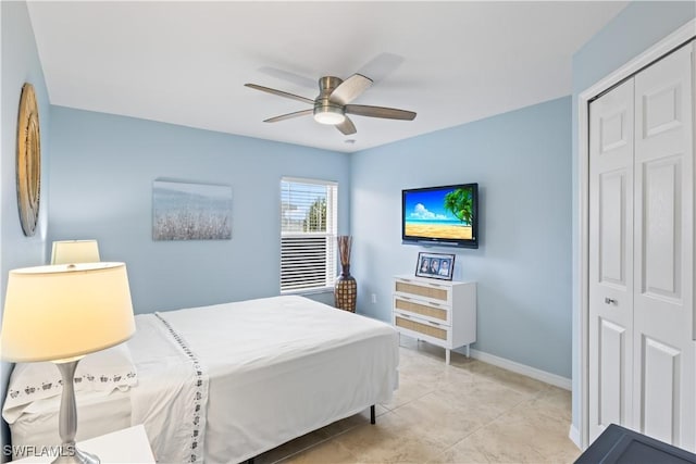 bedroom with light tile patterned flooring, ceiling fan, and a closet