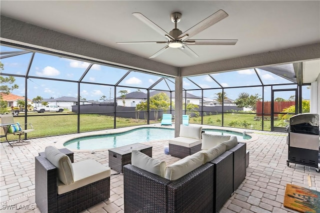 view of patio with a grill, outdoor lounge area, ceiling fan, and glass enclosure