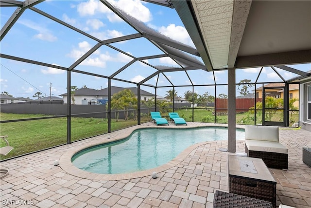 view of pool with a yard, a lanai, and a patio area