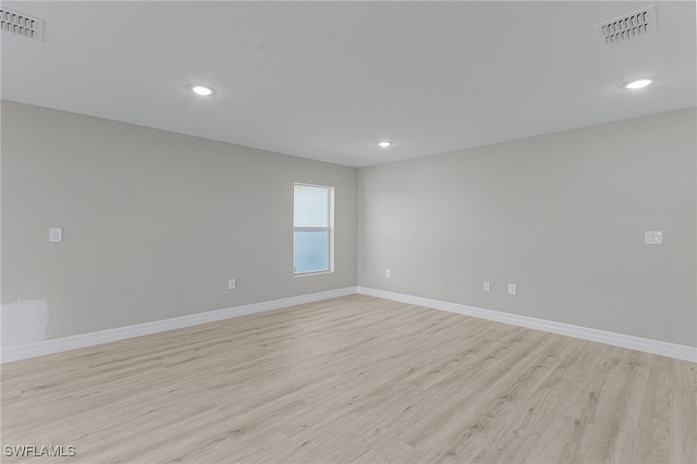 spare room with light hardwood / wood-style floors