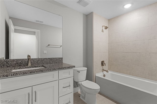 full bathroom with toilet, tiled shower / bath combo, and vanity