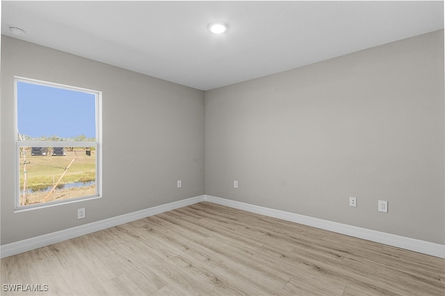 unfurnished room with light wood-type flooring