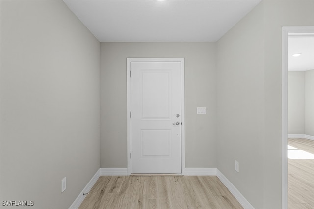 empty room with light hardwood / wood-style flooring