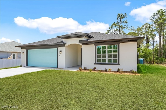 337 Woodburn Dr, Lehigh Acres, FL 33972 - view of front facade with a garage, driveway, stucco siding, and a shingled roof