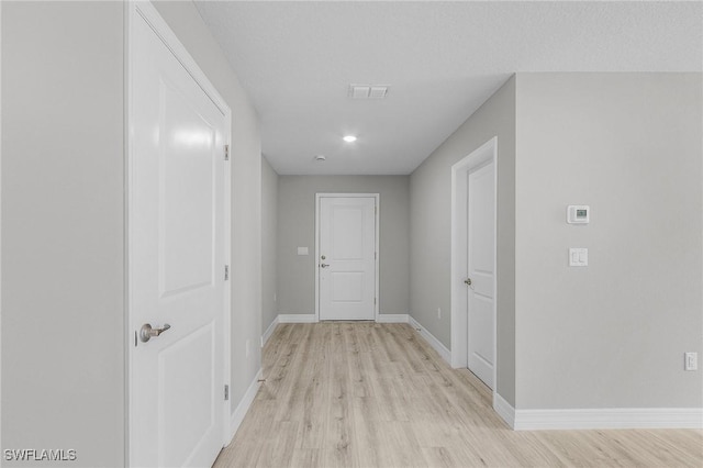 337 Woodburn Dr, Lehigh Acres, FL 33972 - hallway with light wood-style floors and baseboards