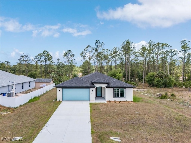 337 Woodburn Dr, Lehigh Acres, FL 33972 - view of front of home featuring driveway, a garage, and a front yard