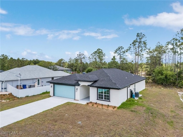 337 Woodburn Dr, Lehigh Acres, FL 33972 - ranch-style home featuring concrete driveway, a garage, a front yard, central AC unit, and stucco siding