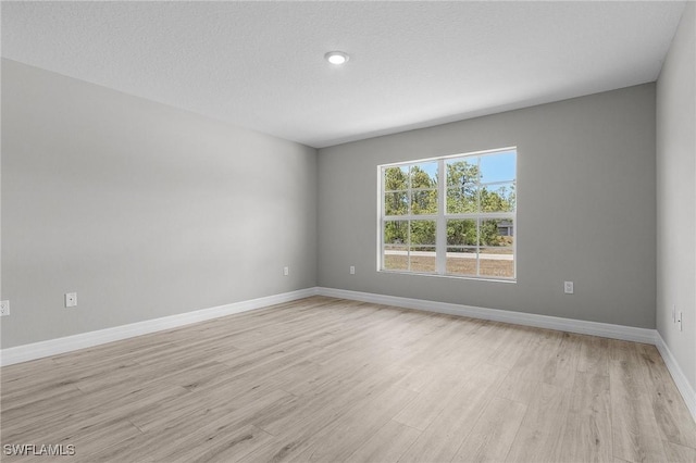 337 Woodburn Dr, Lehigh Acres, FL 33972 - empty room featuring light wood-style flooring and baseboards