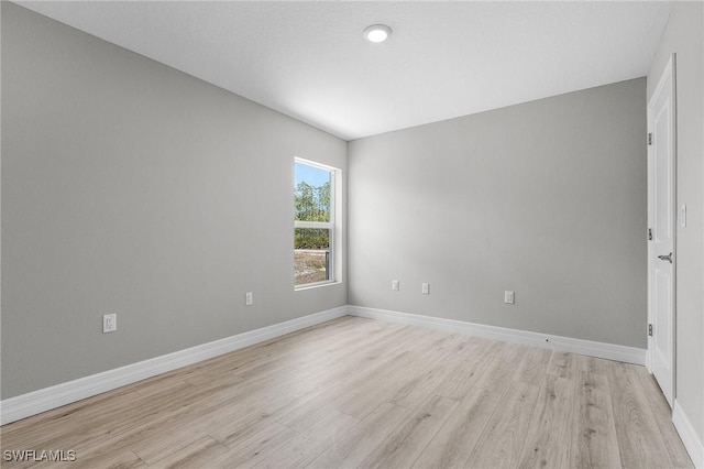 337 Woodburn Dr, Lehigh Acres, FL 33972 - empty room with light wood-style floors and baseboards