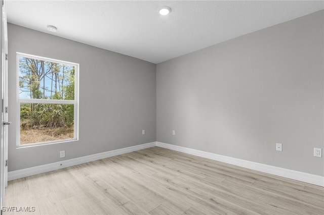 337 Woodburn Dr, Lehigh Acres, FL 33972 - unfurnished room with light wood finished floors, baseboards, and recessed lighting