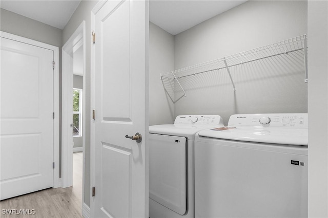 337 Woodburn Dr, Lehigh Acres, FL 33972 - laundry area with light wood-type flooring and separate washer and dryer