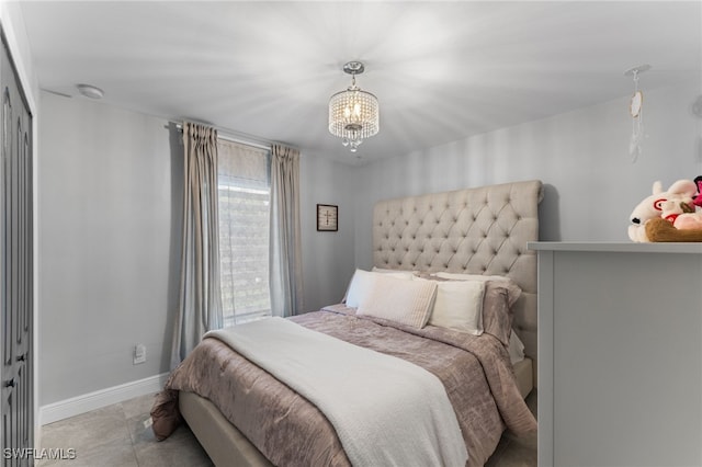 bedroom with a closet and a chandelier