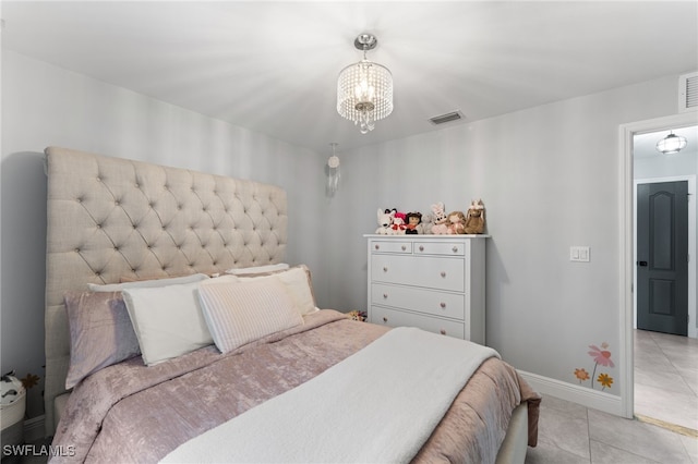 bedroom with light tile patterned flooring and a notable chandelier