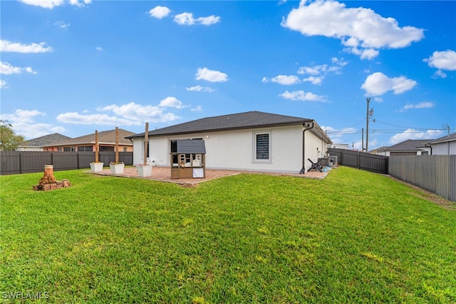 back of house featuring a patio area and a yard