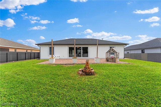 rear view of property featuring a patio area and a lawn