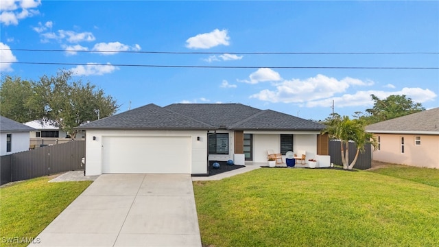 view of front of home with a front yard and a garage