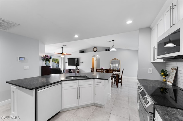 kitchen featuring a kitchen island, white cabinets, pendant lighting, and stainless steel appliances