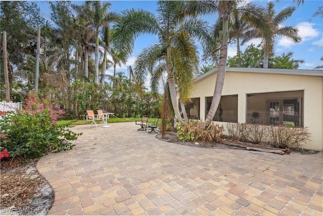 view of patio / terrace featuring a sunroom