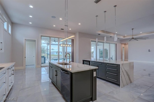 kitchen with hanging light fixtures, dishwasher, a center island with sink, and white cabinetry