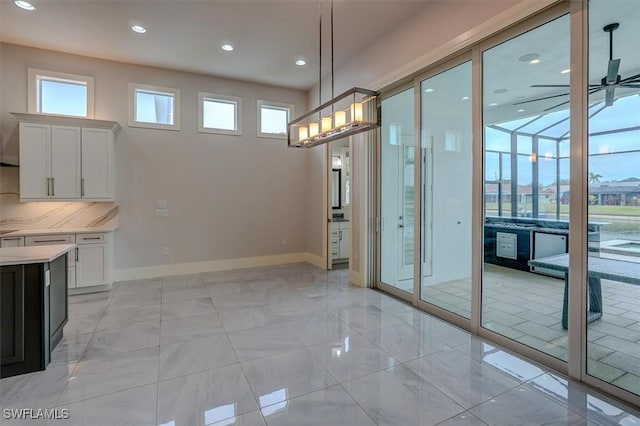 unfurnished dining area with ceiling fan