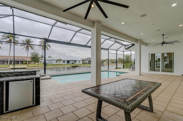 view of pool with a water view and a patio