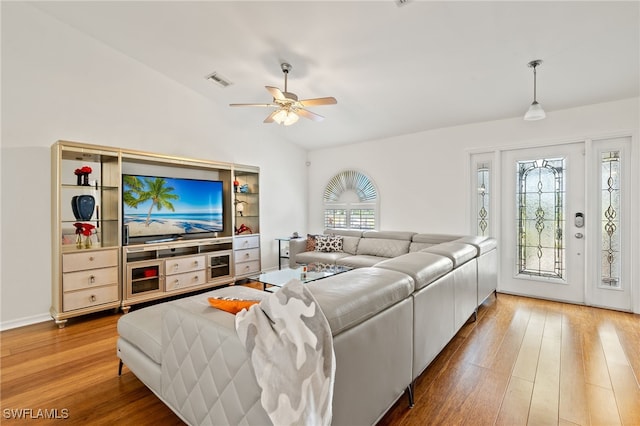 living room with lofted ceiling, ceiling fan, and hardwood / wood-style floors