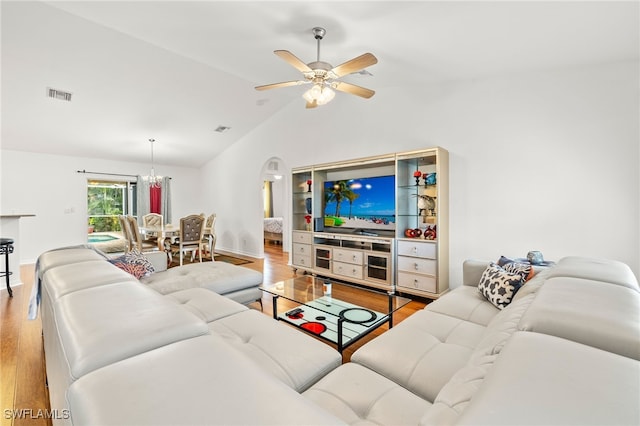 living room with lofted ceiling, wood-type flooring, and ceiling fan with notable chandelier