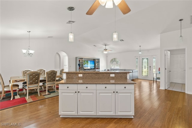 kitchen featuring white cabinetry, pendant lighting, light hardwood / wood-style floors, and a center island