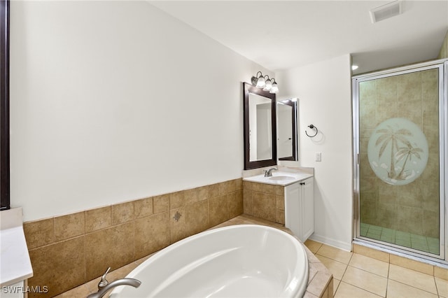 bathroom with plus walk in shower, tile patterned floors, and vanity