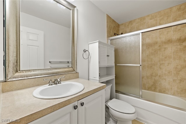 full bathroom featuring toilet, vanity, and bath / shower combo with glass door