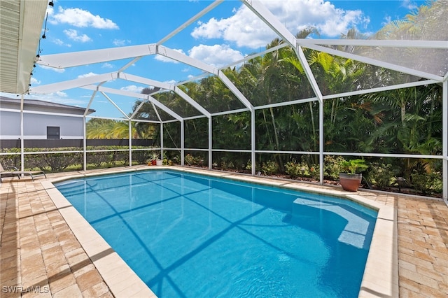 view of pool with a patio area and a lanai