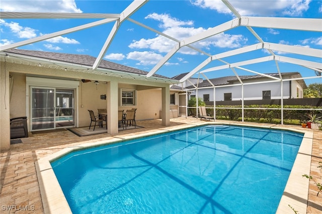 view of pool featuring a lanai, ceiling fan, and a patio