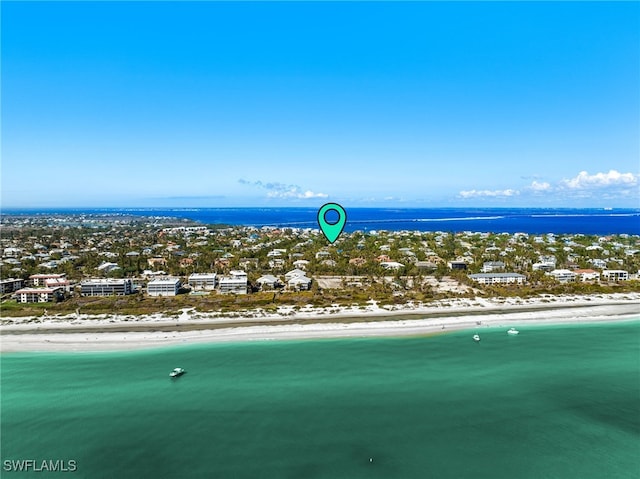 drone / aerial view featuring a water view and a view of the beach