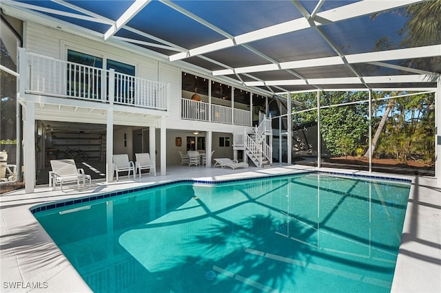 view of pool with a patio area and a lanai