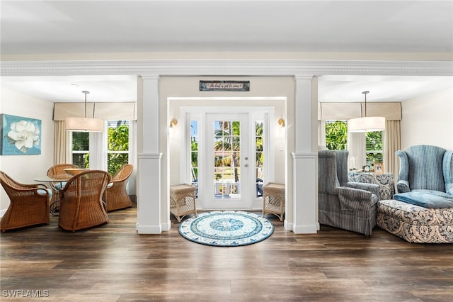 interior space featuring dark wood-type flooring and ornate columns