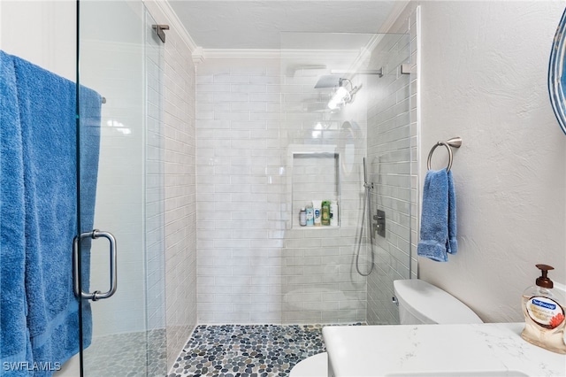 bathroom featuring toilet, an enclosed shower, and crown molding