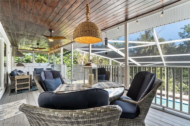 sunroom with wooden ceiling, a wealth of natural light, and ceiling fan