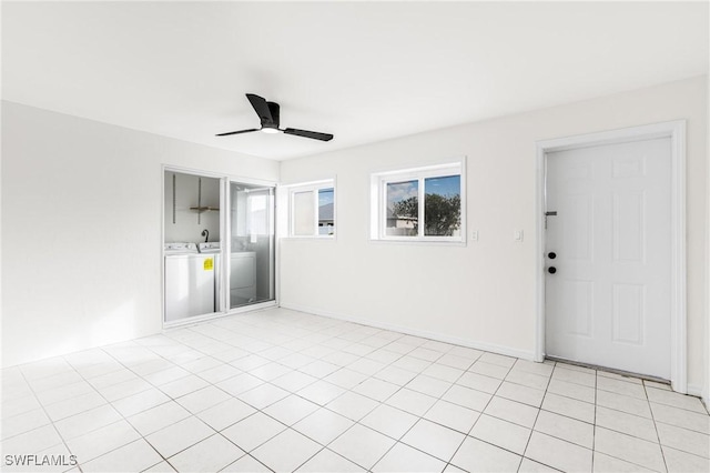 empty room featuring washer and dryer and ceiling fan