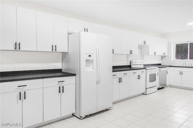 kitchen with tasteful backsplash, light tile patterned floors, white appliances, and white cabinets